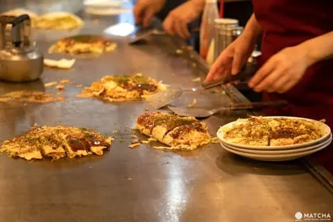 Cooks prepare okonomiyaki at Rei